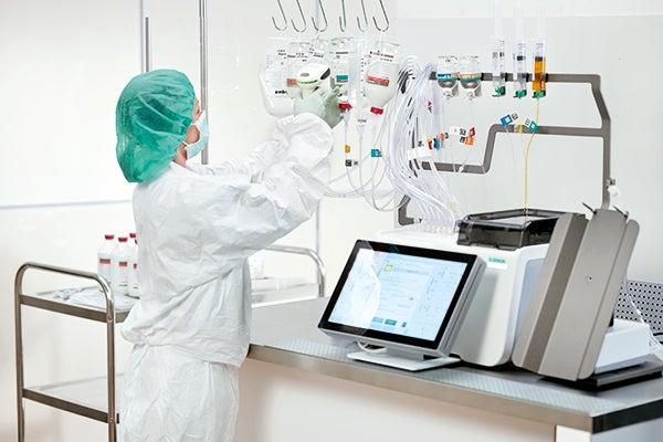 Pharmacist compounding nutrition with automated compounder