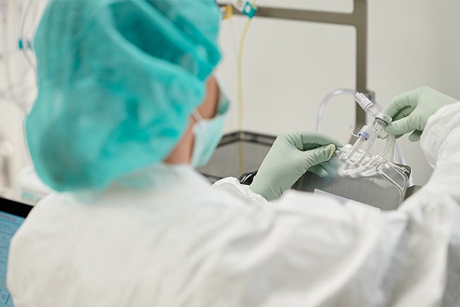 Pharmacist preparing nutrition with APEX automated compounder