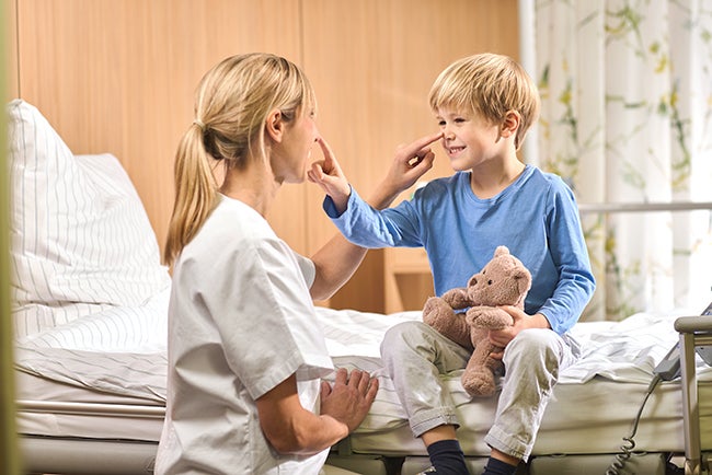 nurse and pediatric patient at eye level example image drug incompatibility